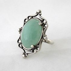 This ring is a sterling silver setting with a 18 mm x 13 mm green Aventurine cabochon set in a beautiful Sterling Silver frame ring and aged to resemble an antiqued heirloom.   Due to the handmade nature of the creation, each piece may have slight variations. All items come with free resize and maintenance for the life of the product. Ring My Bell, Frame Ring, Cameo Ring, Cameo Pendant, Eye Pendant, Ring Sizer, Green Aventurine, Silver Frame, Granada