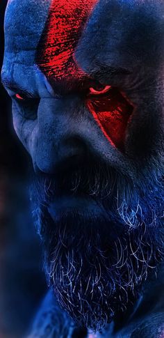 a man with red and blue painted on his face is staring at something in the distance