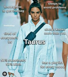 a woman walking down a runway holding a handbag in her right hand and the words taurus on it