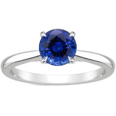 a white gold ring with a blue sapphire stone