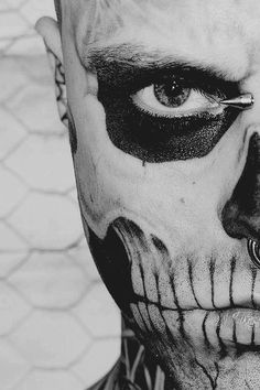 a man with makeup painted to look like a skeleton