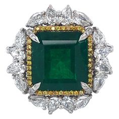 Stunning impressive ring set with a big Colombian emerald and diamonds. Colombian Emerald Minor 11.46 ct Gubelin certified,Minor Pear Shaped diamonds 2,7 Ct Brilliant cut diamonds 0,81 Ct Fancy yellow brilliant diamonds 0,77 Ct Material: 18 kt white gold Ring size: european 57 ( can be adjusted ) Total weight: 21.8 gram Diameter Head of ring: 25.1 mm Formal Green Platinum Diamond Ring, Green Platinum Gemstones Fine Jewelry, Fine Green Platinum Gemstones Jewelry, Green Diamond Fine Jewelry Gemstones, Cluster Green Emerald Ring In Platinum, Green Emerald Cluster Ring In Platinum, Platinum Cluster Emerald Ring, Platinum Green Diamond Ring, Green Platinum Emerald Ring With Cluster Shape