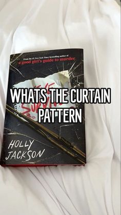 the book whats the curtain pattern is laying on top of a white bed sheet