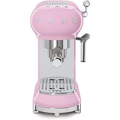 a pink coffee machine sitting on top of a white table