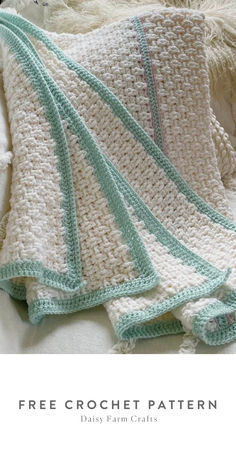 a crocheted blanket sitting on top of a bed