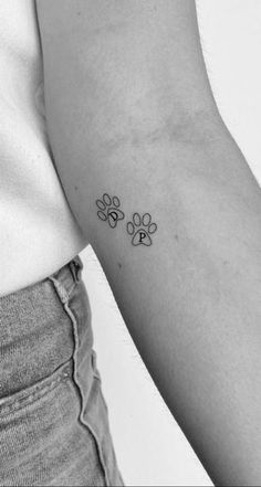 a small paw tattoo on the left arm