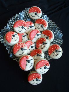 cupcakes decorated with red and white polka dots are arranged on a glass platter