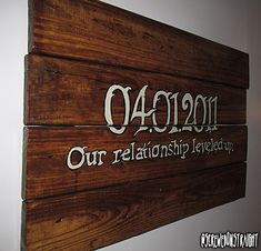 a wooden sign hanging on the side of a wall that says, our relationship revealed