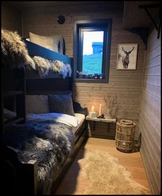 a bed room with a bunk bed and a rug on the floor next to a window