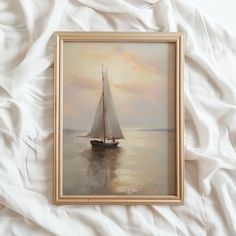 a painting of a sailboat in the water on a white sheeted bedding