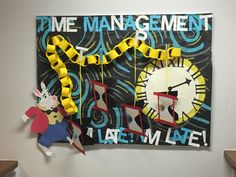 a clock and some yellow streamers hanging on the wall next to a sign that says time management