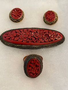 Vintage polished looking Cinnabar set with Pendant, Pierced earrings, and Ring. Brass filigree surrounds all of the pieces, horizontal bar closure on Pendant. Each piece has matching Floral Cinnabar design. Pendant measures 3" long by 1 1/4" wide, ring measures1" long by 3/4" wide, Earrings measure 1" long by 3/4" wide. Measurements including the surrounding filigree. Pendant and ring has markings "made in China". Please email with questions, free shipping. Red Carved Jewelry For Wedding, Brass Filigree, Wide Ring, Filigree Pendant, Earrings Vintage, Pierced Earrings, 1950s Vintage, Pendant Earrings, Earings Piercings