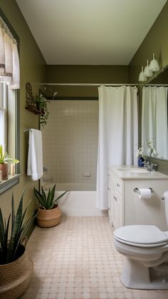 a white toilet sitting next to a bath tub in a bathroom under a window with curtains