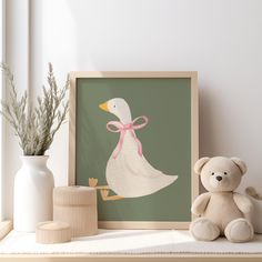 a duck with a pink bow sitting next to a teddy bear on a shelf in front of a window