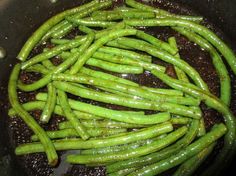 some green beans are cooking in a skillet