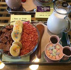 two trays filled with different types of food and drinks on top of a table