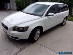 a white car parked in front of a house