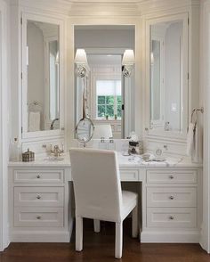 a white chair sitting in front of a bathroom vanity