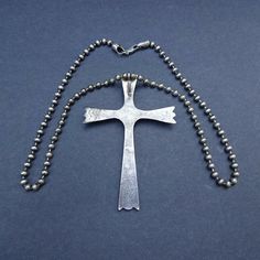 "HUGE ZUNI CROSS PENDANT with STERLING SILVER CHAIN DESCRIPTION: This impressive old Zuni cross pendant, paired with a sterling silver chain from Michele Baratta (Anglo) will be a lovely addition to your collection of fine vintage Native American jewelry. MEASUREMENTS: Pendant measures 4\" x 2 3/4\" Shepherd's hook Chain measures 24\" WEIGHT: Pendant weighs 36.7 grams Chain weighs 34.7 grams Total weight: 71.4 grams SIGNED: Cross is unsigned STERLING: Cross is unsigned, verified sterling" Antique Sterling Silver Cross Pendant Necklace, Engraved Cross Pendant Necklaces For Collectors, Vintage Sterling Silver Cross Pendant Necklace, Antique Cross Necklace With Large Pendant, Vintage Silver Engraved Cross Necklace, Vintage Engraved Silver Cross Necklace, Sterling Silver Stamped Cross Jewelry, Collectible Cross-shaped Jewelry With Large Pendant, Collectible Spiritual Cross Pendant Necklace