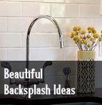 a black sink sitting under a faucet next to a white tiled bathroom wall