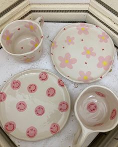 three dishes with flower designs on them sitting on a counter top next to each other