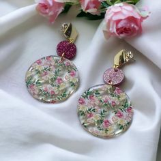 "Introducing our exquisite wedding floral earrings, a perfect blend of elegance and charm for your special day. These stunning earrings feature a unique design with two laser-cut circles elegantly connected by jump rings, creating a graceful and eye-catching composition. The top circle, measuring 0.5\" in diameter, is meticulously crafted from pink glitter acrylic, adding a touch of sparkle and glamour to the design. The shimmering pink hue beautifully complements the floral theme, creating a ca White And Green Floral Wedding, Elegant Bridal Jewelry, Laser Cut Earrings Acrylics, Laser Cut Earrings, Glitter Acrylic, Glitter Acrylics, Floral Theme, Earrings Pink, Wedding Floral