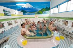 a group of people sitting in a large bath tub