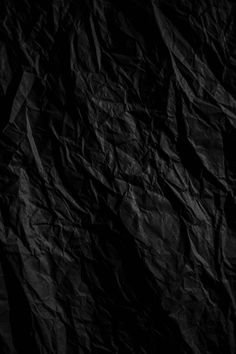 a black background with wrinkled paper on it