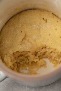 a cup filled with cake batter on top of a table