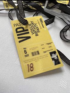 a close up of a luggage tag on a white surface with black and yellow tags