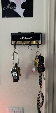 there are several keys hanging on the wall