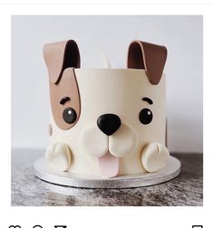 a cake with a dog's face on top of it and the words happy birthday written below