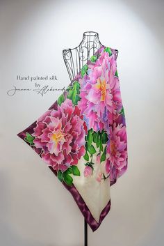 a pink flowered dress on a mannequin stand with the words hand painted silk written above it