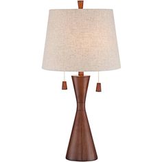 a wooden table lamp with a white shade on it's side and a brown base