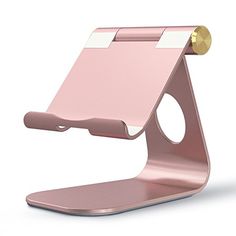 a pink and gold desk phone holder with a white strip on the top that is attached to it