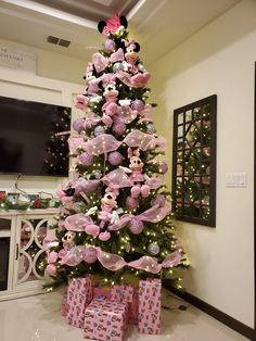 a pink christmas tree with minnie mouse decorations