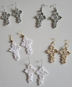 six pairs of crocheted earrings on a white surface