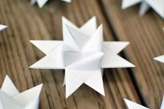 several white origami stars on a wooden surface