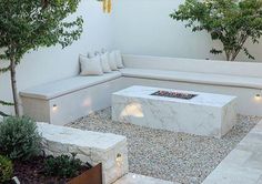 a white couch sitting next to a fire pit