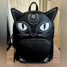 Brand New With The Tags Tik Tok Famous Viral Mad Engine Witchy Black Cat Back Pack In Black And White Adjustable Shoulder Straps Silver Hardware Front Zipper Pocket/Top Loop (H) 11”X (W) 9” 5” Deep Any Questions?? Leave A Comment Black Cat Tik Tok Famous Viral Witch Spooky Halloween Ghosts Skulls Black School Backpack With Cat Design, Black Cat Design Backpack For School, Black Cat Design School Backpack, Black Backpack With Cat Design, Black Backpack With Cat Design For Daily Use, Black Travel Bag With Cat Print, Black Cat Design Backpack, Black Cat Design Standard Backpack, Trendy Black Backpack With Cat Design