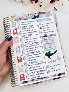 a hand holding a planner with the words and numbers on it