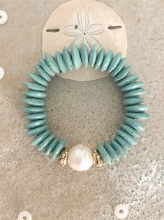 Nothing says summer like the color aqua. This chunky statement bracelet is a little boho mixed in with a bit of hippie chic. Made with fabulous Krobo beads and topped off with an amazing Baroque Pearl accented with two hand made gold bronze accent beads. If preferred, can switch the gold to silver. Shown with a companion piece which can be purchased separately. Materials: Krobo Beads Gold Bronze Beads Bracelet length comes in various sizes, see drop down menu for your preference, please select y Krobo Beads, Color Aqua, Turquoise Glass, Coastal Design, Statement Bracelet, Beads Bracelet, Hippie Chic, Baroque Pearls, Bracelet Sizes