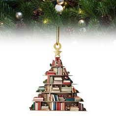 a christmas tree made out of books with ornaments hanging from it's sides and an ornament on the top