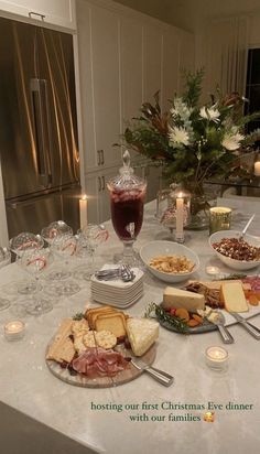 a table full of food and drinks on it with candles in front of the counter