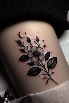 a woman's thigh with flowers and stars on it