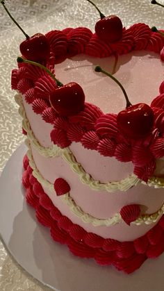 a heart shaped cake with cherries on top