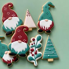 decorated christmas cookies are arranged on a green surface