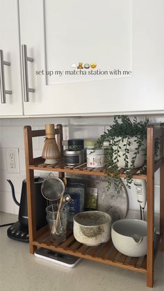 a kitchen shelf filled with pots and pans