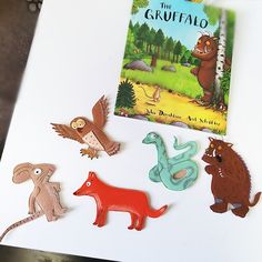 the children's book is next to some animal magnets