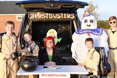 a group of people in costumes standing next to a van